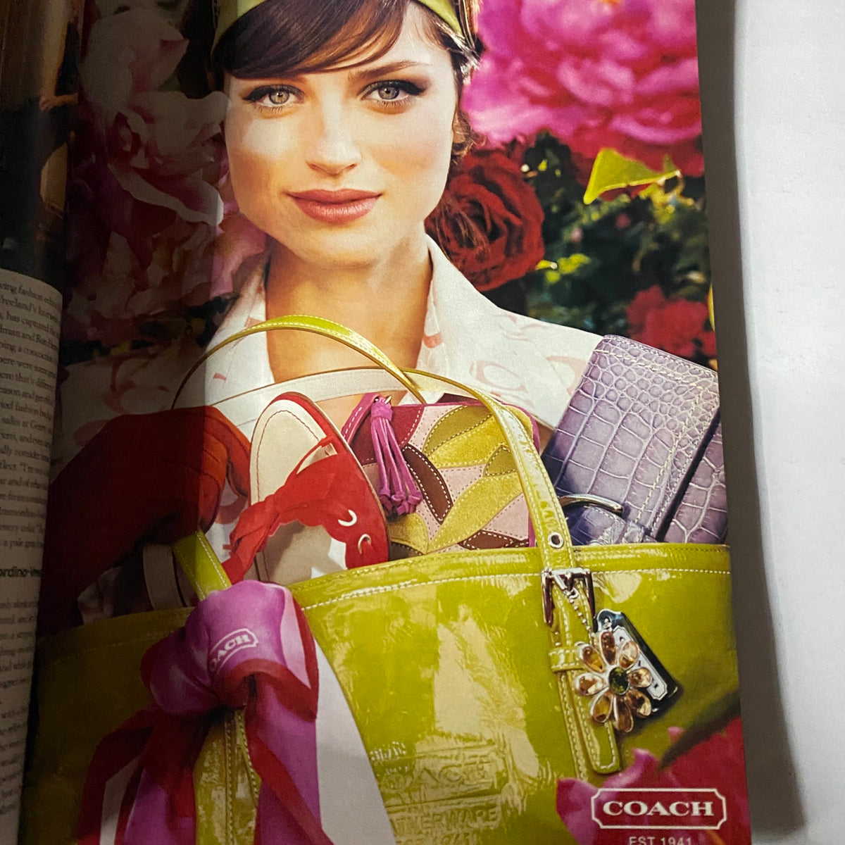 W Magazine April 2004 Gemma Ward Cover featuring a model with a Coach bag, showcasing vibrant fashion accessories against a floral backdrop.