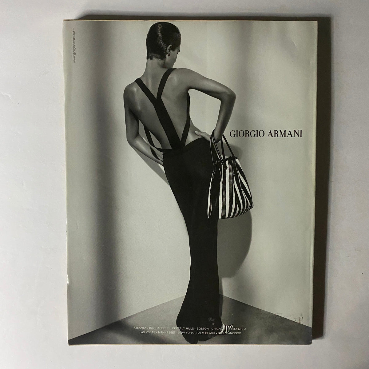 W Magazine February 2004 The A-List Cameron Diaz Cover displaying an elegant advertisement for Giorgio Armani featuring a model in a chic black dress with an open back and striped handbag.