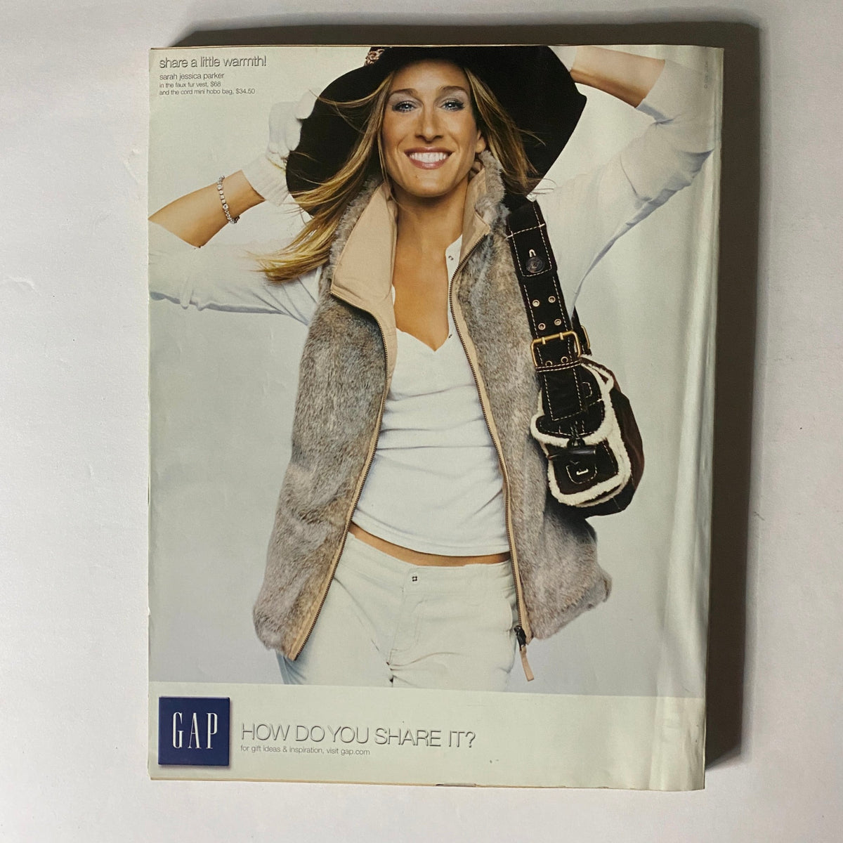 GAP advertisement featuring a stylish model in a fashionable vest and handbag, promoting a chic winter look, illustrating contemporary fashion styles.