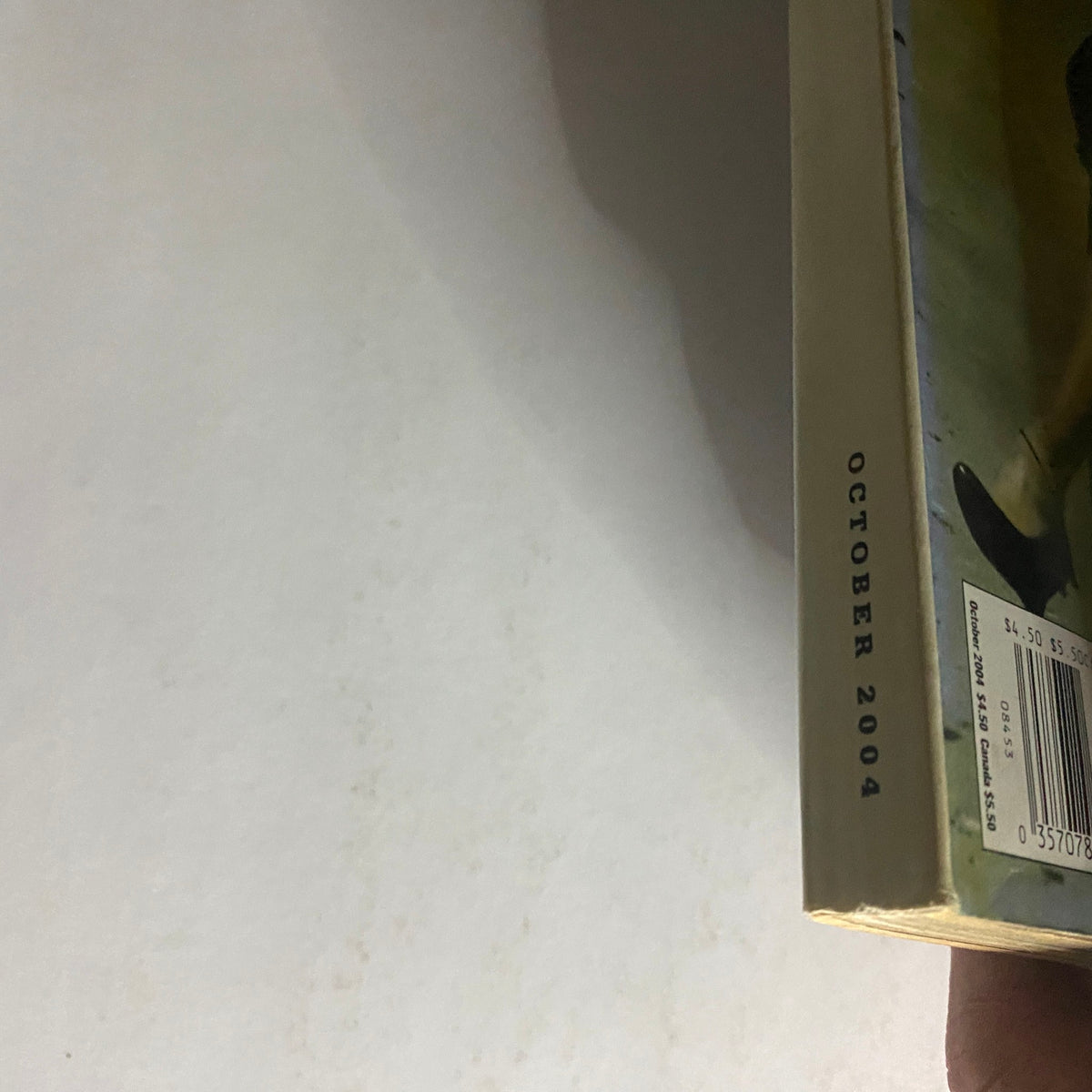 Side view of W Magazine October 2004, displaying the publication date and spine, highlighting its vintage appeal and great condition for collectors.