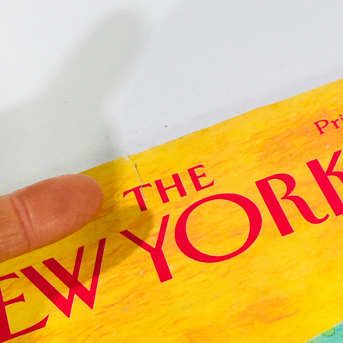 Close-up view of the spine of The New Yorker April 20 1992 magazine showcasing the title with a tear on the edge. Vintage publication.