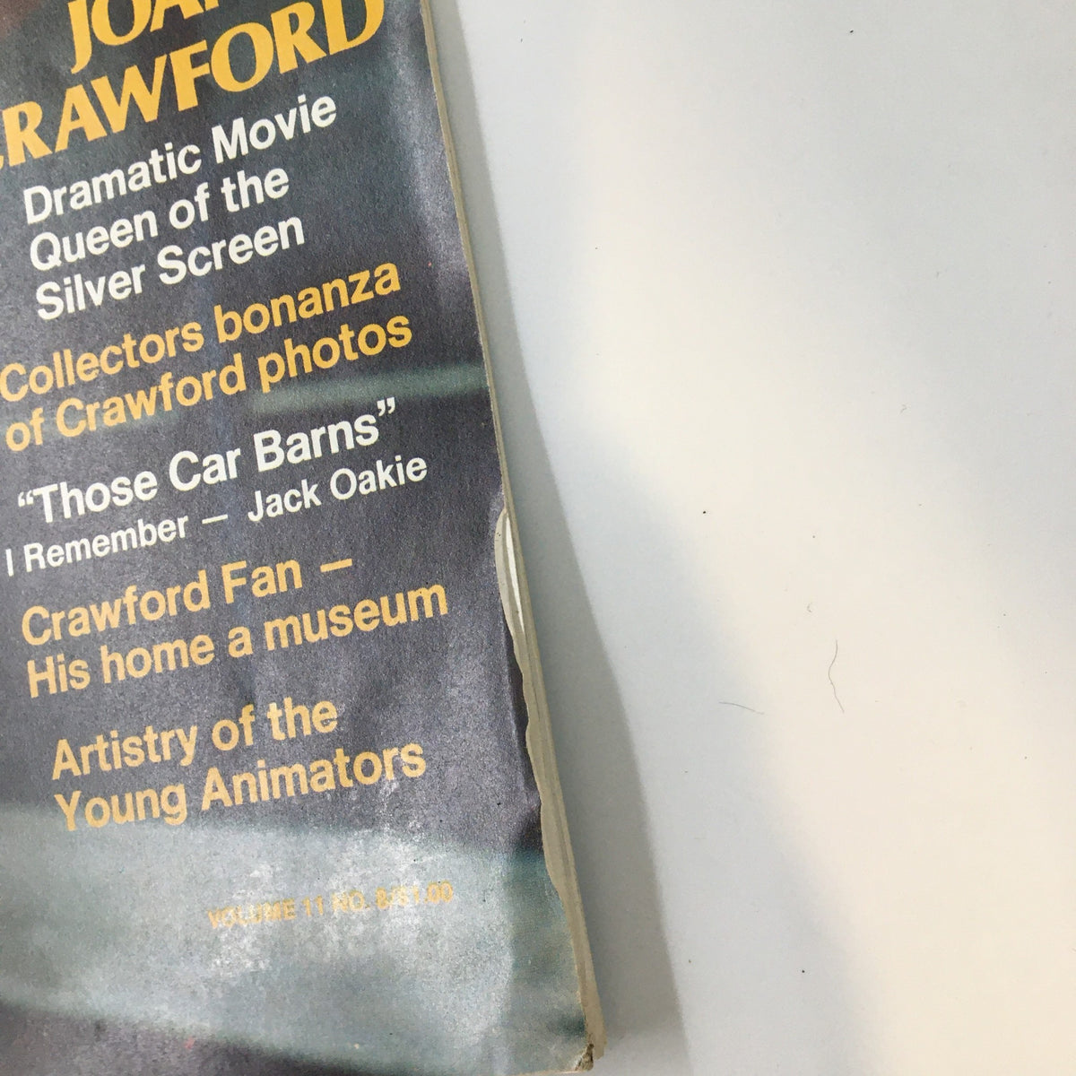 Detail shot of the cover text from the VTG Hollywood Studio Magazine August 1977, highlighting Joan Crawford as the dramatic movie queen and collector's bonanza of photos.