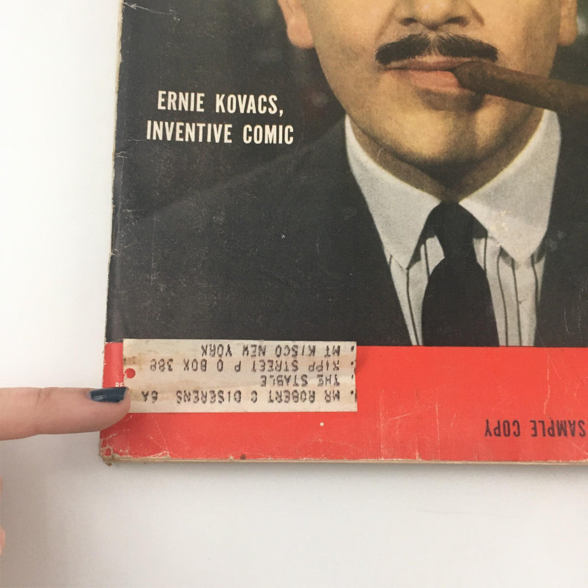 Close-up of the cover of VTG Life Magazine from April 15, 1957, highlighting the title 'Ernie Kovacs, Inventive Comic' along with a sample copy label, showcasing the magazine's vintage appeal.