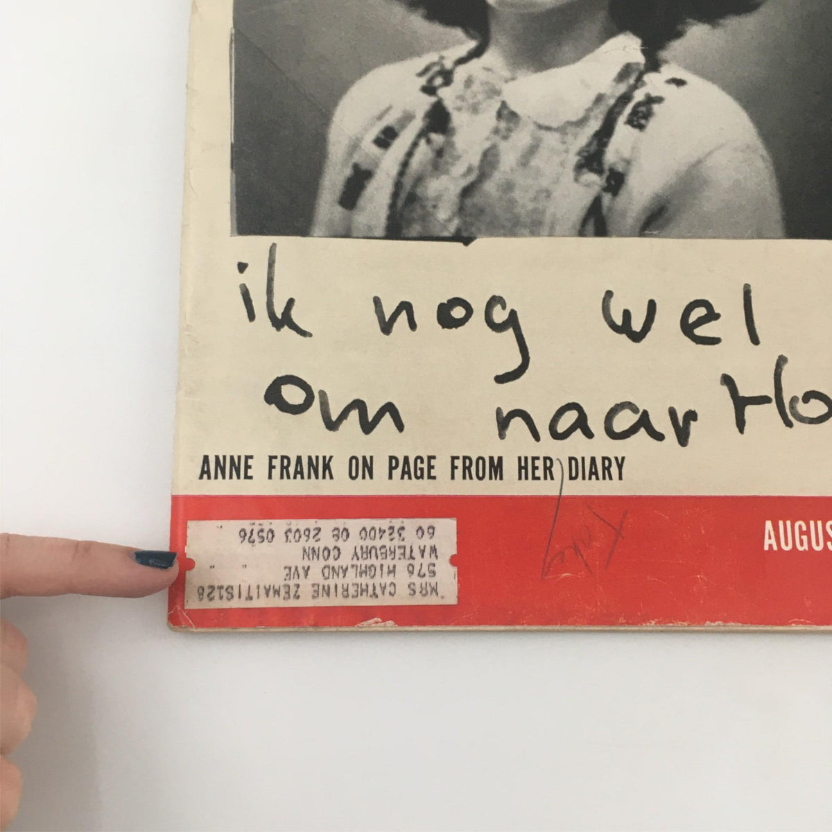Close-up of the Vintage Life Magazine cover from August 18, 1958, showcasing Anne Frank with handwritten notes on the page. The magazine includes details about her diary and its impact on history.