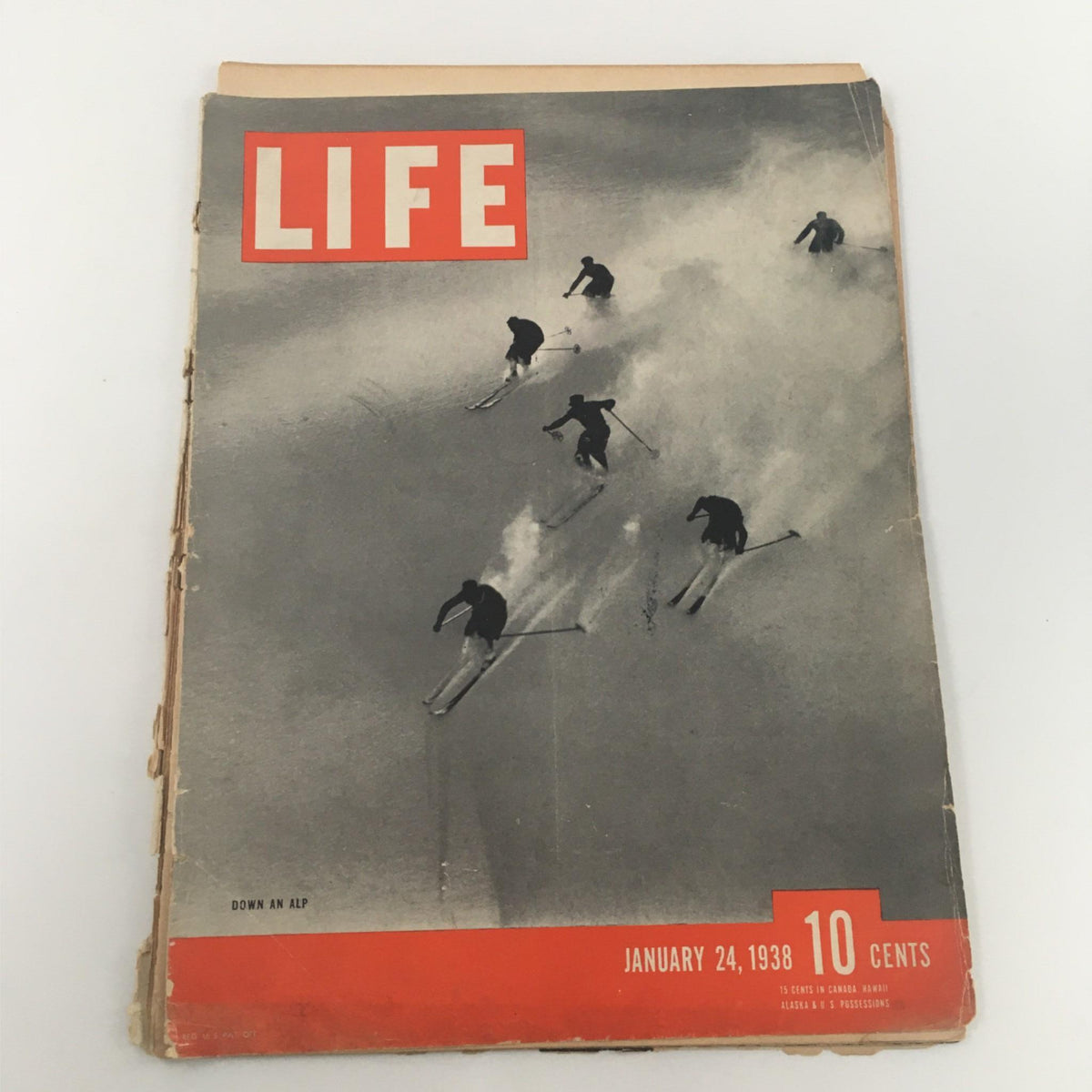 Front cover of Life Magazine from January 24, 1938, featuring an iconic skiing scene with skiers racing down an alpine slope, showcasing the adventurous spirit of winter sports.