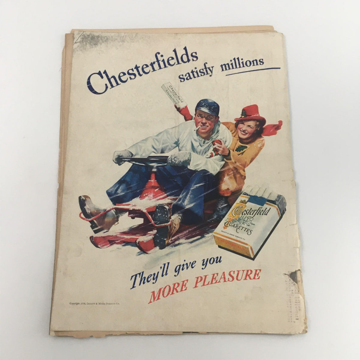 Back cover of Life Magazine from January 24, 1938, displaying a vintage advertisement for Chesterfield cigarettes, illustrating a cheerful couple enjoying a snow ride together.
