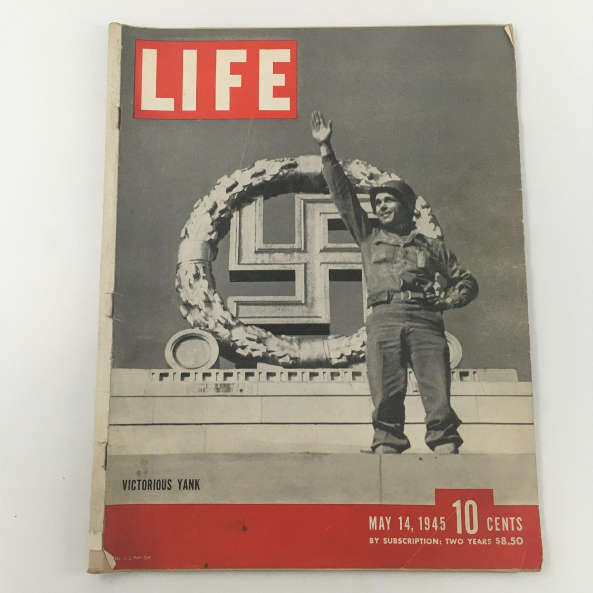 Cover of VTG Life Magazine from May 14, 1945, featuring 'Victorious Yank', illustrating a soldier celebrating victory over Nazi Germany with a historic background.