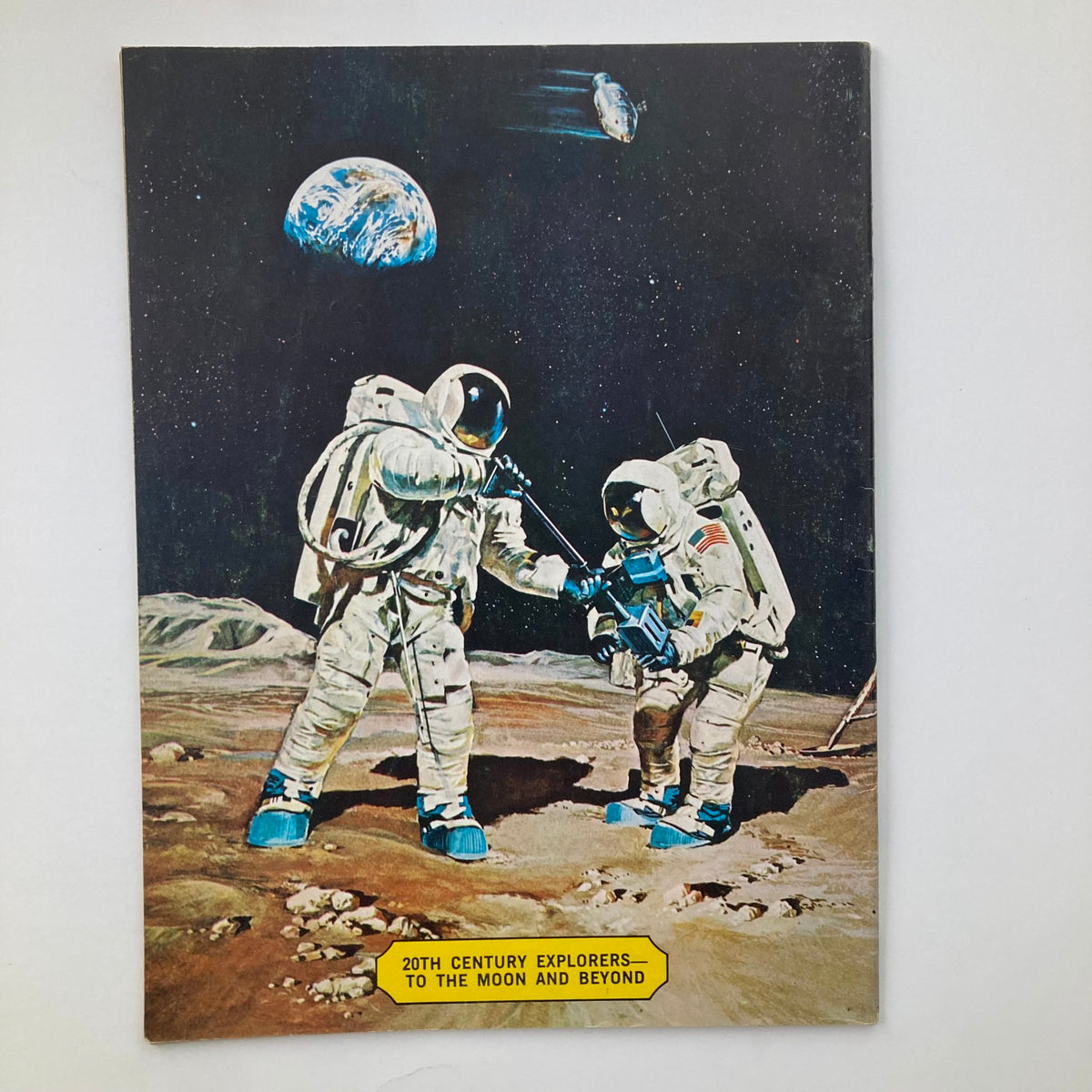VTG Man on the Moon Magazine July 1969 back cover depicting astronauts in space with Earth in the background, illustrating the theme of lunar exploration.