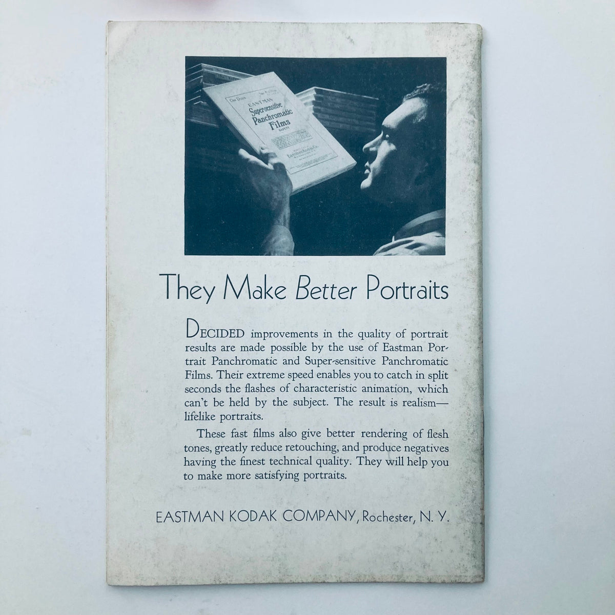 Back cover of VTG Photographic Review Magazine January 1933 titled 'The Film Margin', displaying an advertisement for Eastman Panchromatic Films with a portrait photographer reading about the film, highlighting improvements for better portrait results.