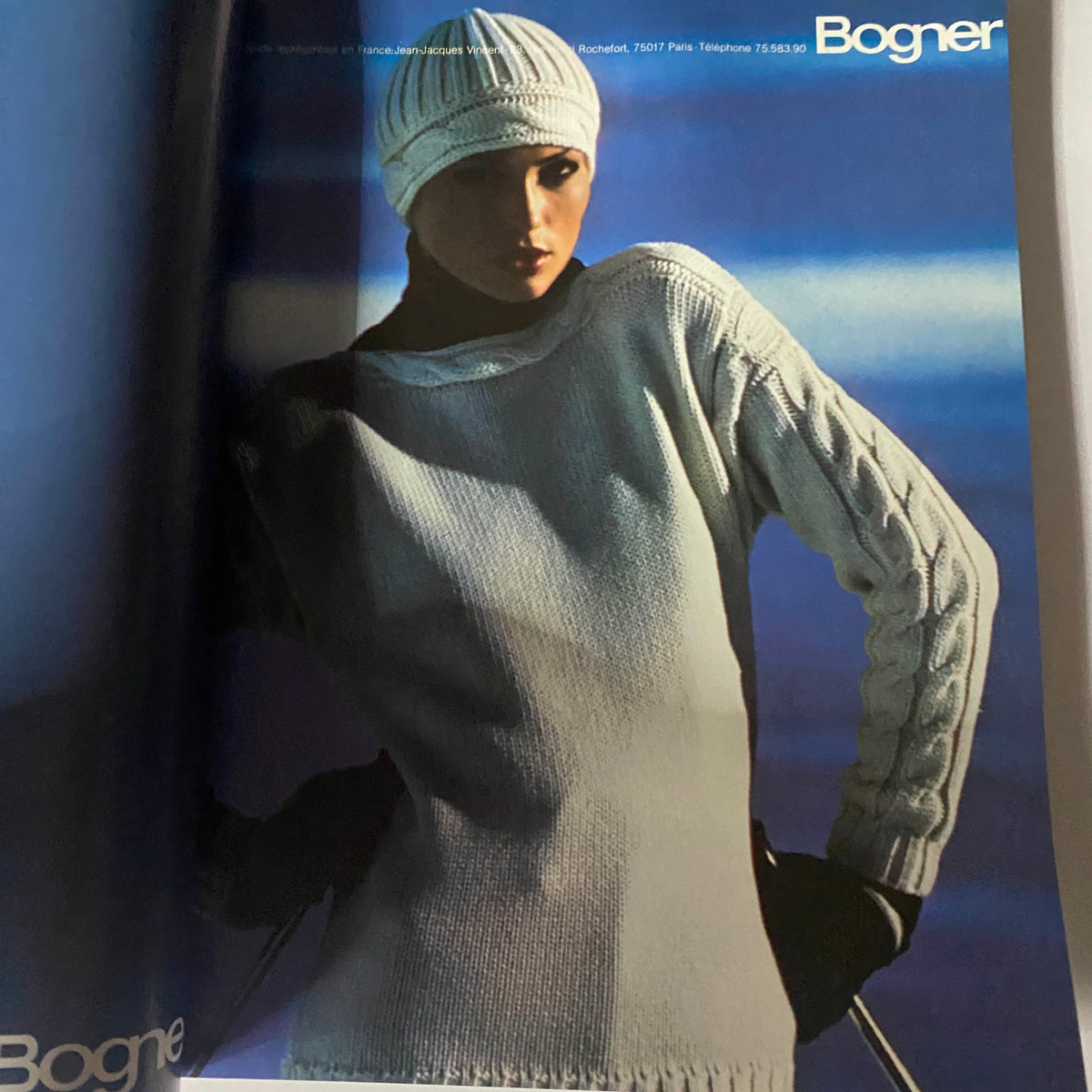 Model wearing a white winter sweater and hat, featured in Vogue Paris Magazine October 1976, representing vintage fashion styles.