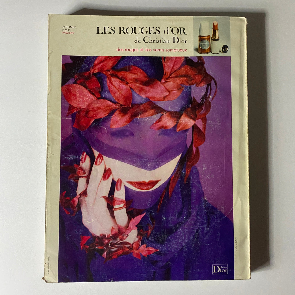 Colorful fashion advertisement for 'LES ROUGES d'OR' by Christian Dior, included in Vogue Paris Magazine September 1976 Dayle Haddon Cover, highlighting luxurious makeup and nail products.