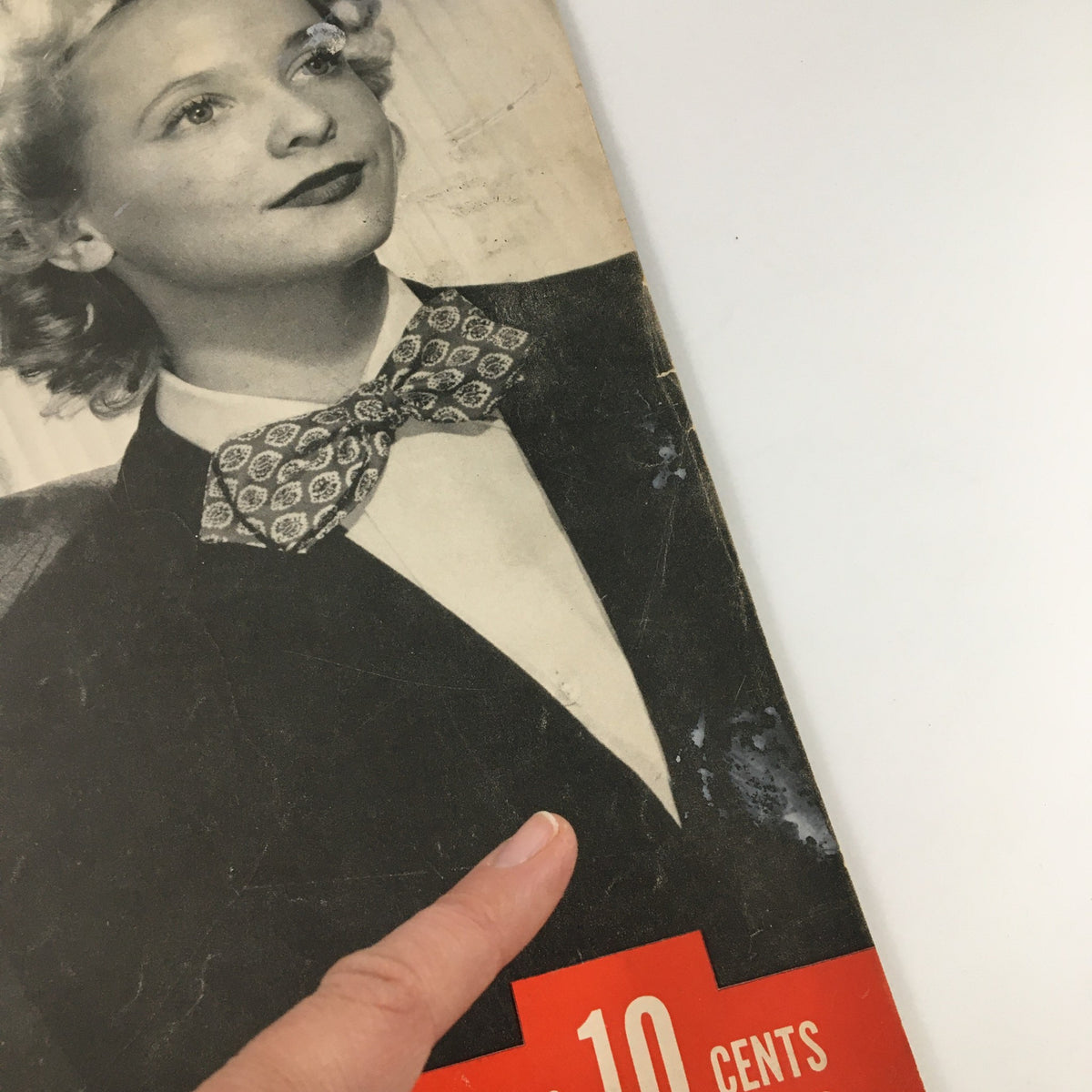 Detailed shot of the VTG Life Magazine cover from March 1, 1943, focusing on a woman wearing a bow tie, showcasing the vintage style and wear.