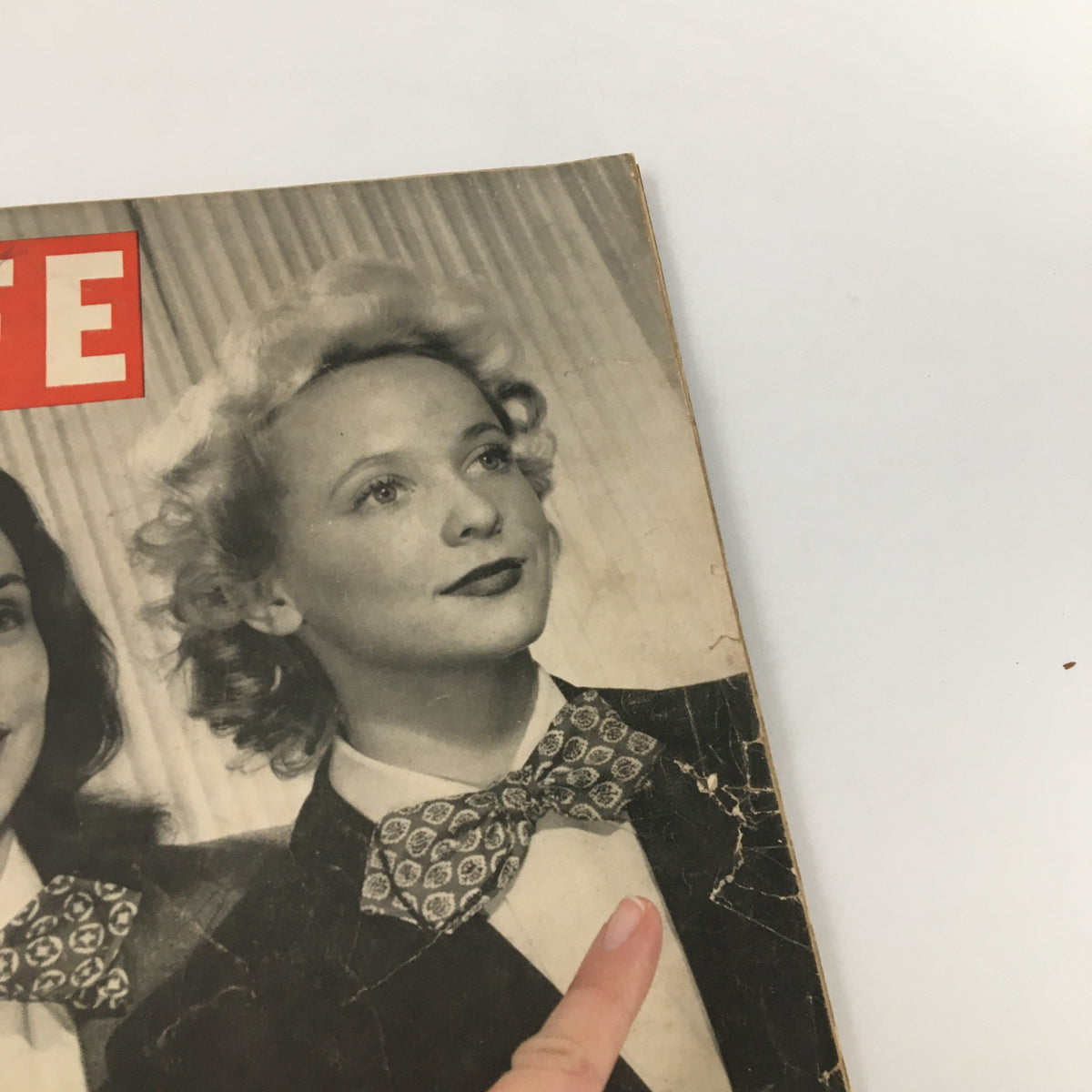 Close-up view of the cover of VTG Life Magazine March 1 1943, highlighting a woman with a bow tie, reflecting vintage fashion from the era.
