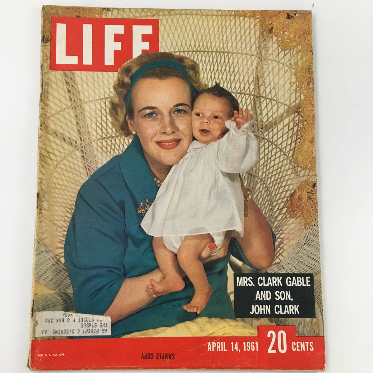 Vintage Life Magazine cover from April 14, 1961 featuring Mrs. Clark Gable holding her son John Clark, highlighting Hollywood glamour and family life.
