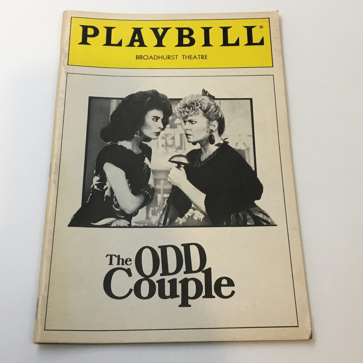 1985 Playbill for Neil Simon's The Odd Couple at Broadhurst Theatre, featuring a classic black and white image of two characters.