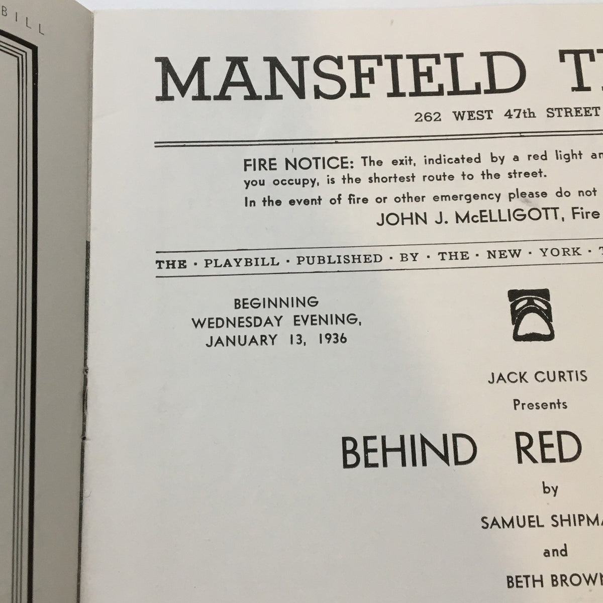 Close-up view of the inside content of the 1936 Playbill from Mansfield Theatre with information about the play 'Behind Red Lights' by Samuel Shipman, including a fire notice and performance details.