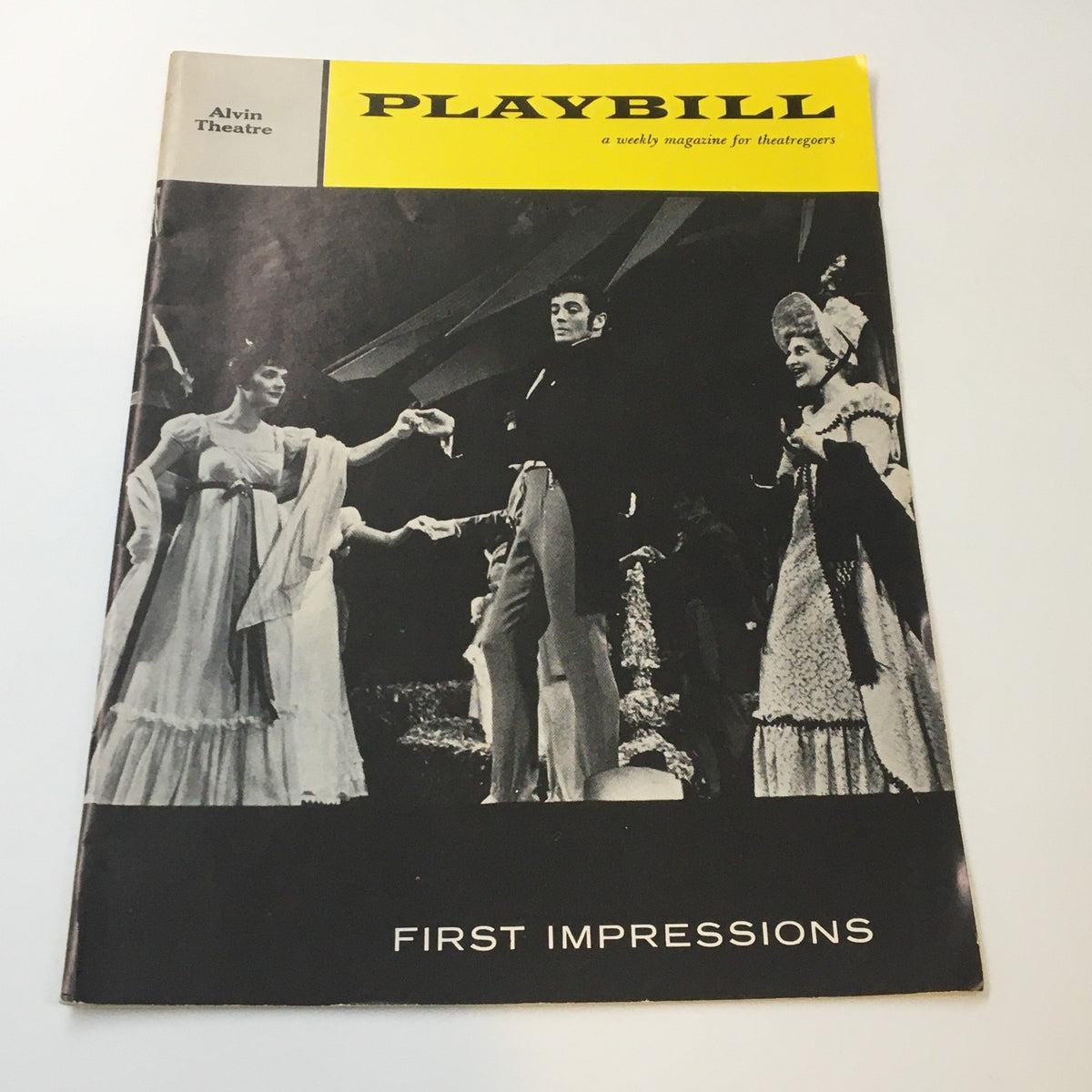1959 Playbill Alvin Theatre featuring Polly Bergen in First Impressions, showcasing a vintage cover design with black and white photographic elements and theatrical imagery.