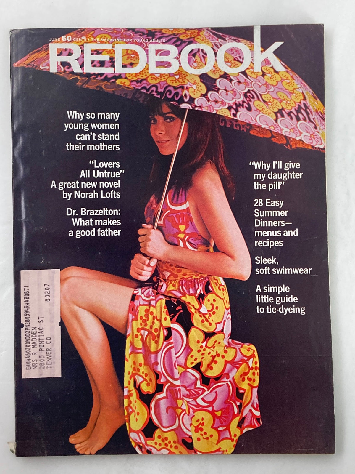 Cover of VTG Redbook Magazine June 1970 featuring an iconic photograph of Marianne Nestor, showcasing vibrant fashion with a colorful floral print dress and a decorative umbrella.