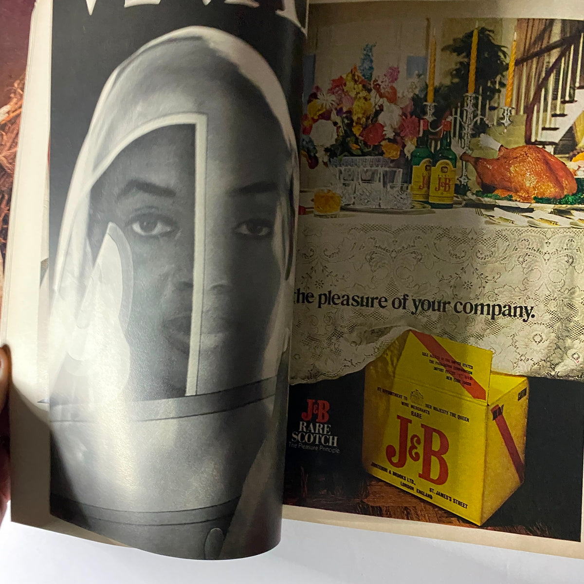 Interior page from Vogue Magazine November 1973 featuring a striking advertisement with a model, emphasizing the essentials of luxury living and fine spirits.