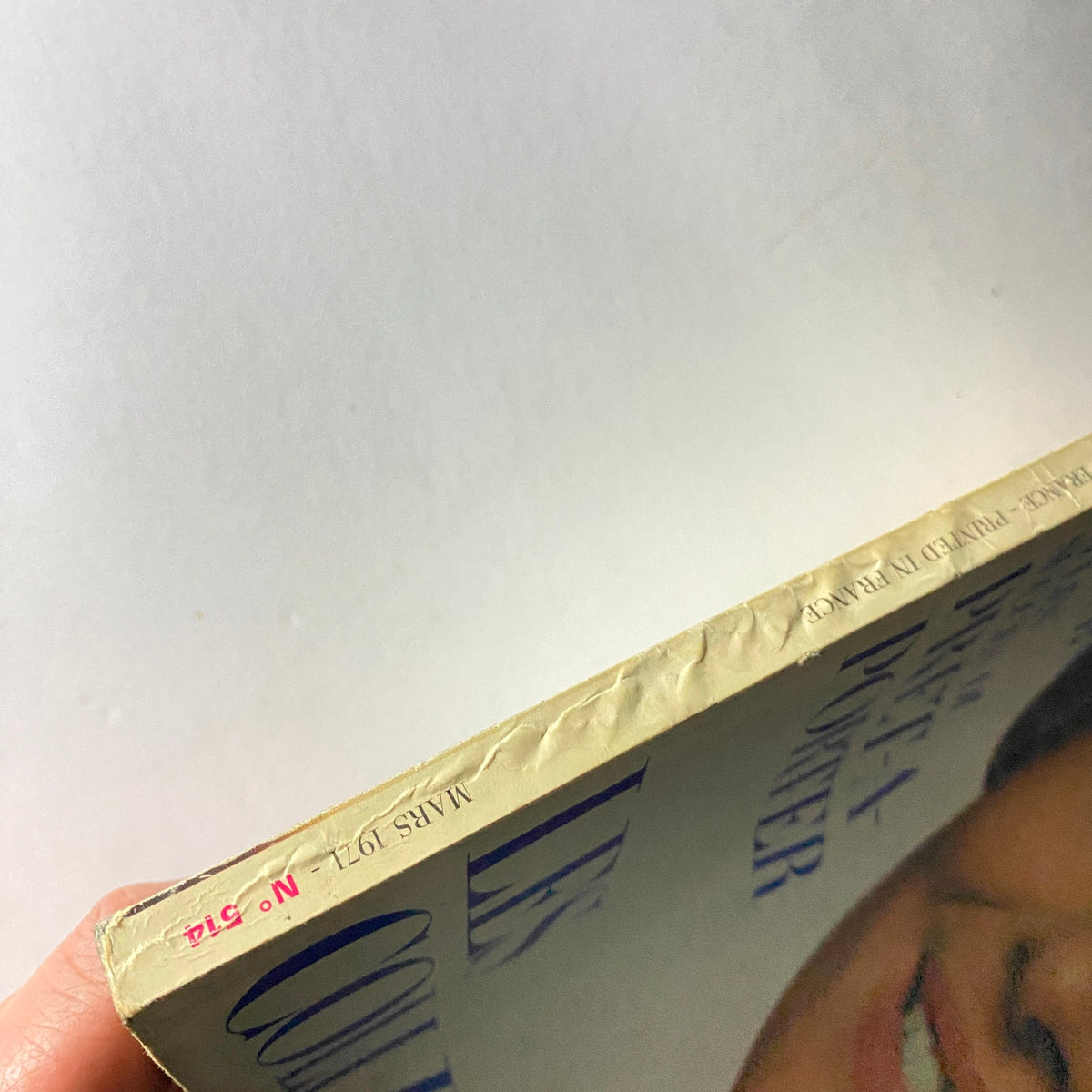 Side view of the March 1971 Vogue Paris Magazine showing minor wear, highlighting the vintage condition and authenticity of this collectible featuring Audrey Hepburn.