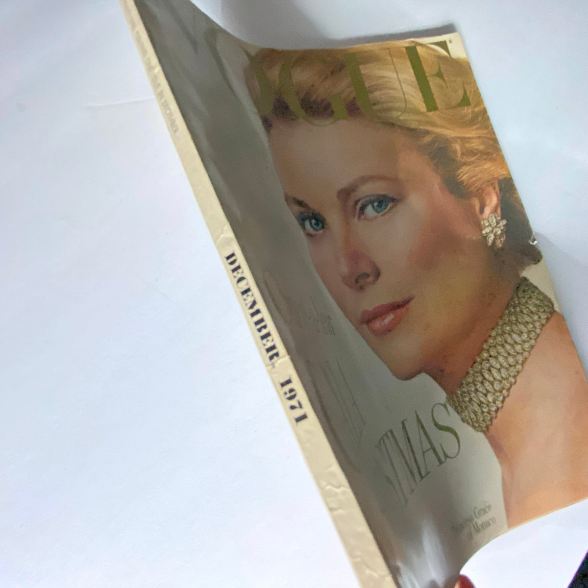 Close-up view of Vogue Magazine December 1971 showing the spine and cover with Princess Grace, emphasizing its vintage aesthetic as the Gala Christmas Issue.