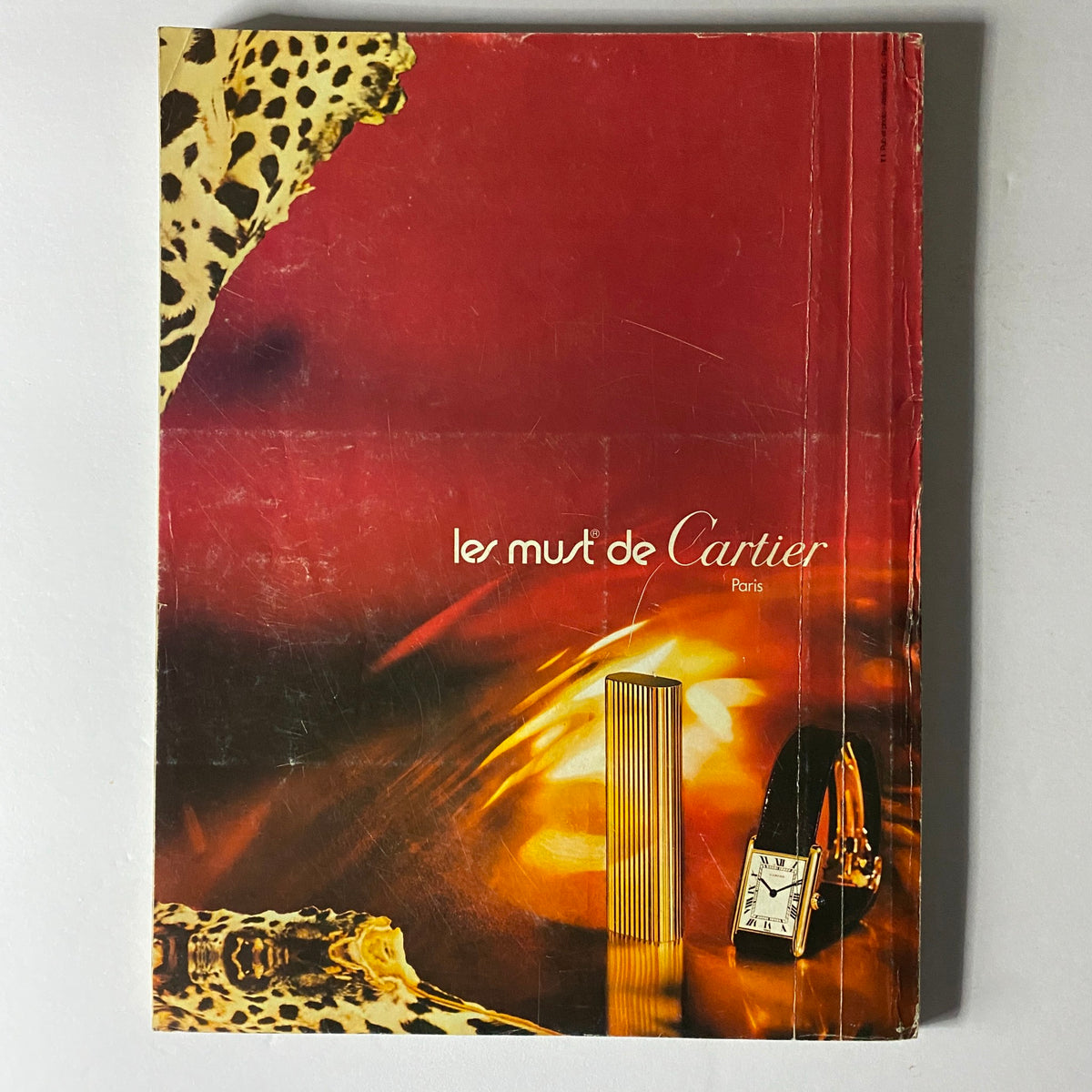 Cover of Les Must de Cartier brochure, showcasing luxury fashion items with an elegant design, complementing the theme of Vogue Paris Magazine February 1975.