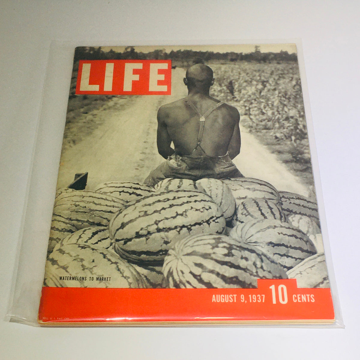 Cover of Vintage Life Magazine: August 9, 1937 - Watermelons To Market featuring a man seated on a pile of watermelons with a rural landscape in the background, highlighting the agricultural focus of the issue.