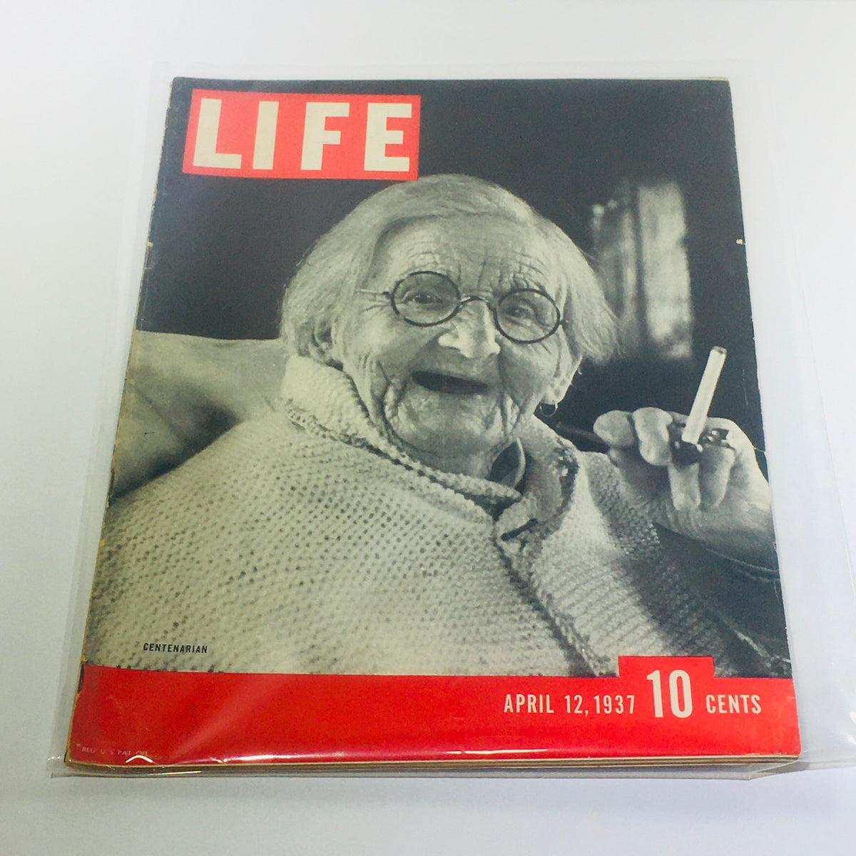 Vintage Life Magazine: April 12, 1937 - Centenarian cover featuring an elderly woman with glasses smiling and holding a cigarette. A glimpse into early 20th century culture.