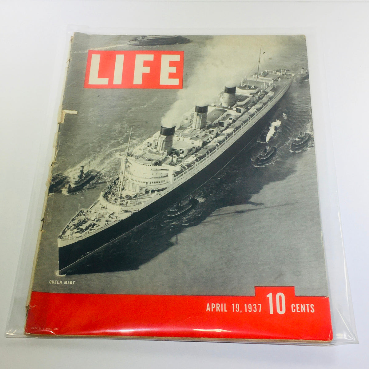 Vintage Life Magazine featuring Queen Mary on the cover, April 19, 1937, showcasing the luxurious ocean liner surrounded by tugboats.