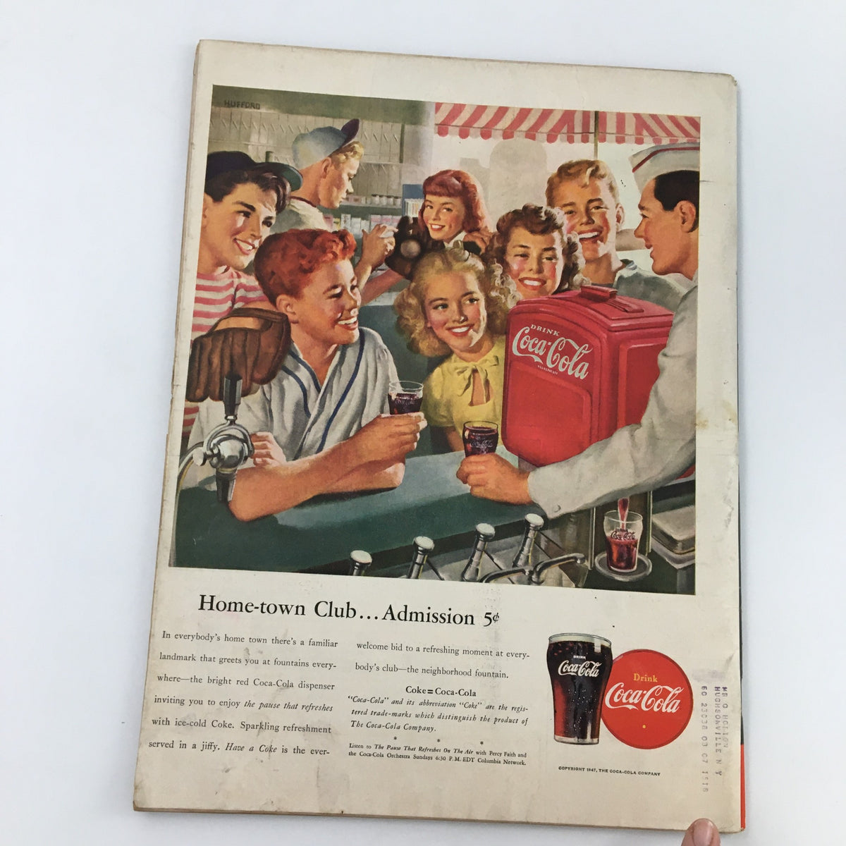 Back cover of Vintage Life Magazine from August 25, 1947, showcasing a Coca-Cola advertisement with a social gathering at a soda fountain.