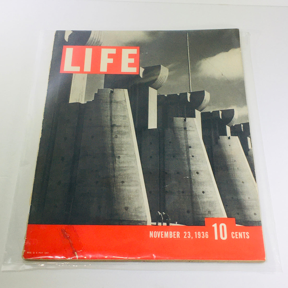 Vintage Life Magazine cover from November 23, 1936 featuring the Fort Peck Dam, showcasing a dramatic black and white photograph with prominent red title and price.