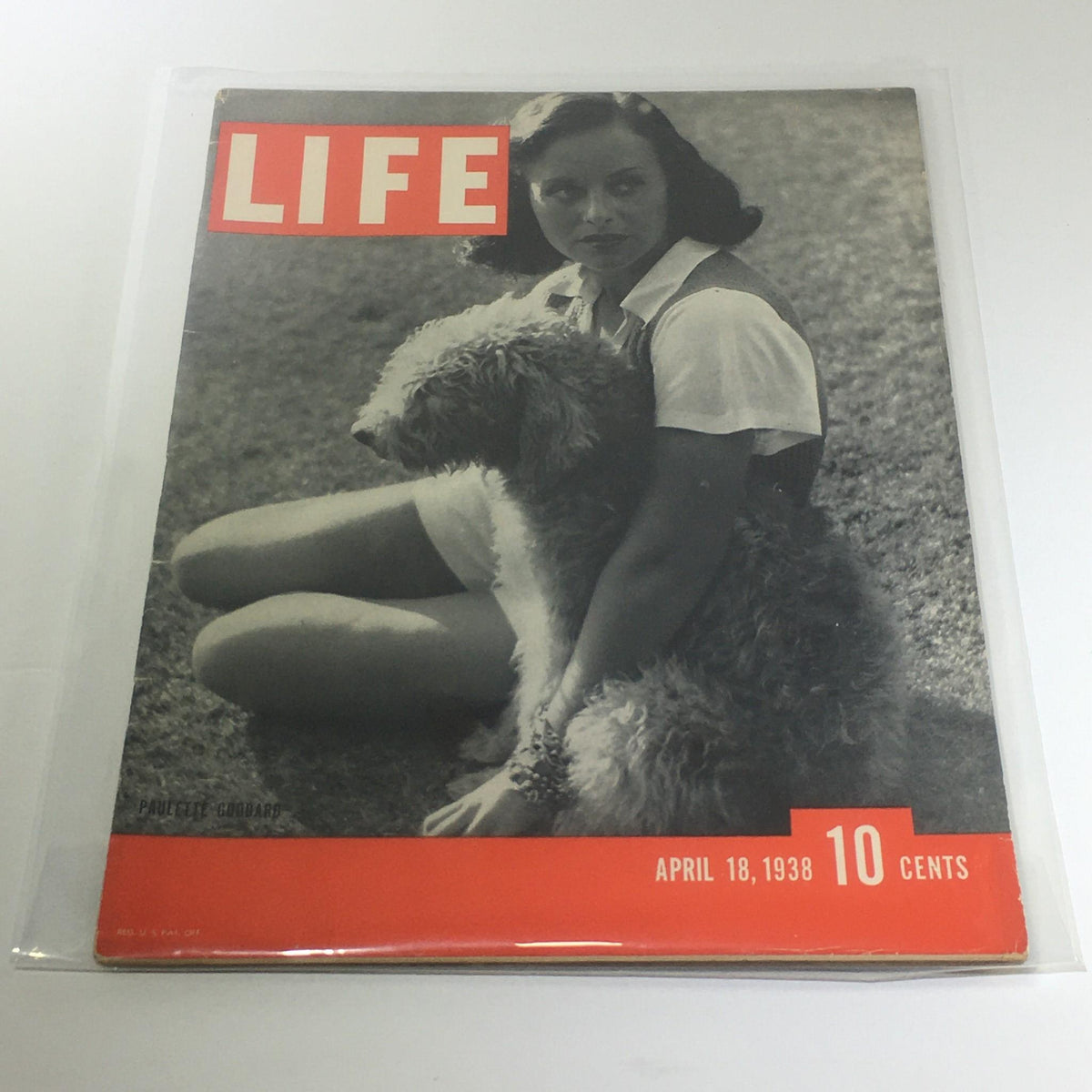 Vintage Life Magazine cover from April 18, 1938 featuring Paulette Goddard sitting with a dog, showcasing the elegance and style of the late 1930s.