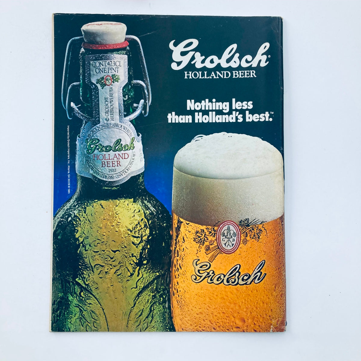 Vintage advertisement page for Grolsch Holland Beer featured in a July 1985 edition of National Lampoon Magazine.