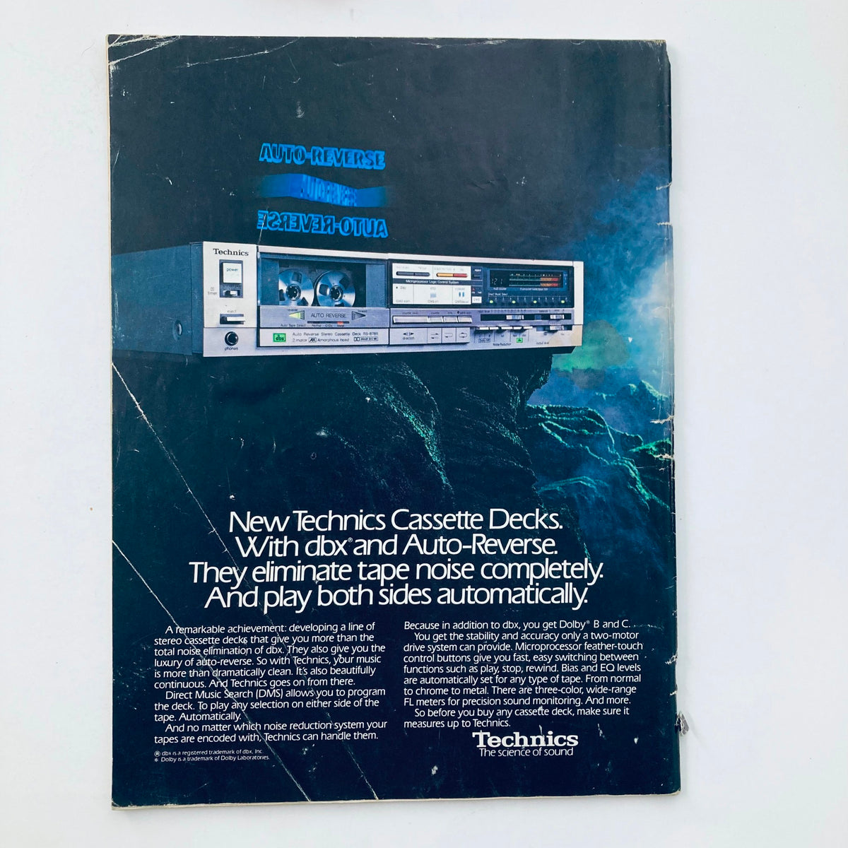 Back cover of the VTG National Lampoon Magazine December 1984 showcasing an advertisement for Technics cassette decks with features like auto-reverse and noise reduction.