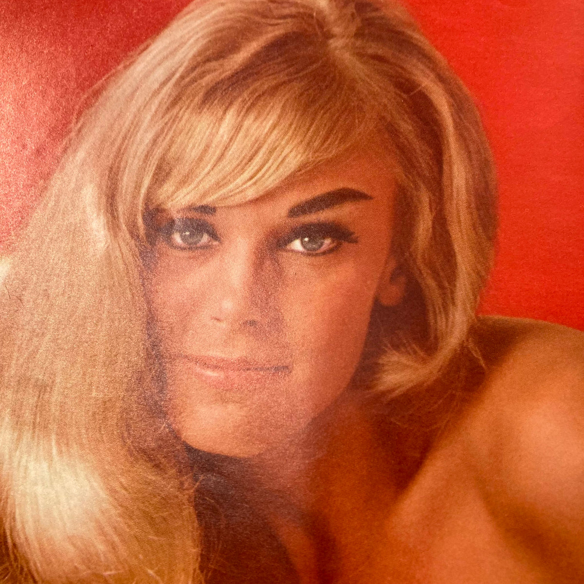 Portrait of a blonde woman with long hair and striking eyes, from the centerfold of the vintage Playboy magazine June 1963 featuring Jayne Mansfield.