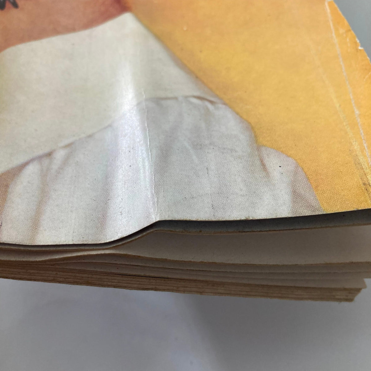 Close-up image of the corner of a folded page from the Vintage Playboy Magazine May 1963, showing wear and condition.