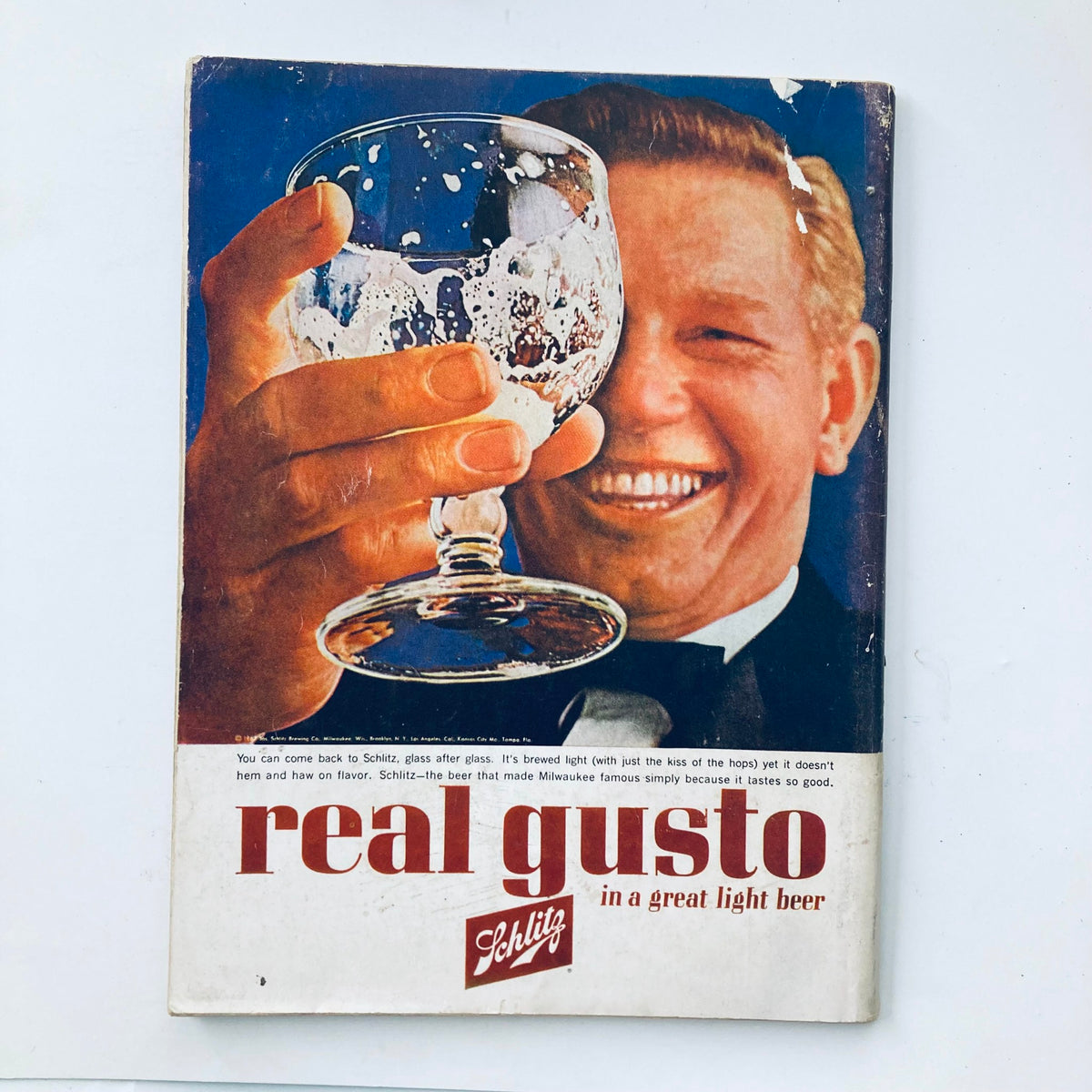 Advertisement from the VTG Playboy Magazine April 1963, featuring a cheerful man enjoying a drink, reflecting 1960s pop culture.