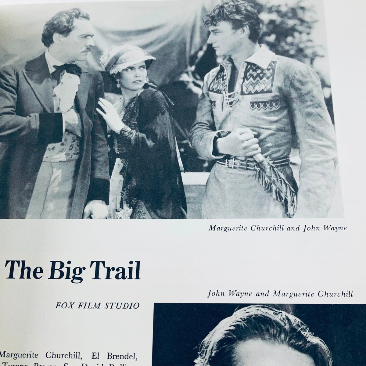 Black and white photograph from VTG 1976 The Films of John Wayne by Mark Ricci, Boris & Steve Zmijewsky, showcasing John Wayne with Marguerite Churchill in a scene from The Big Trail.