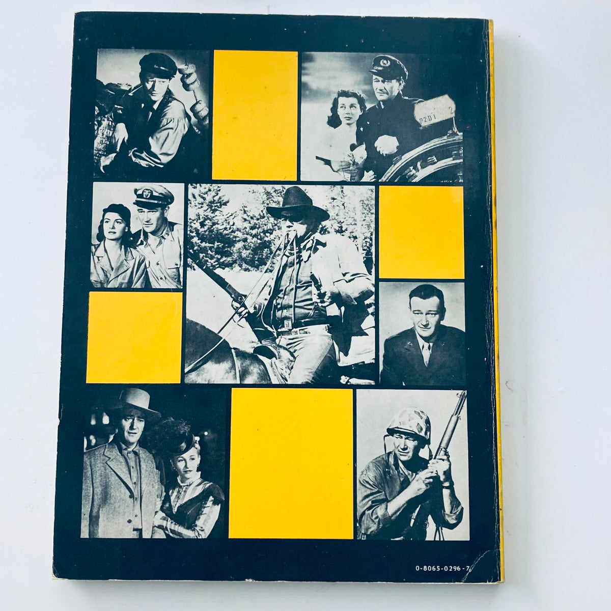 Image of the back cover of a magazine with a collage of scenes from classic films, showcasing various characters in black and white, linked to VTG 1976 The Films of John Wayne by Mark Ricci, Boris & Steve Zmijewsky.
