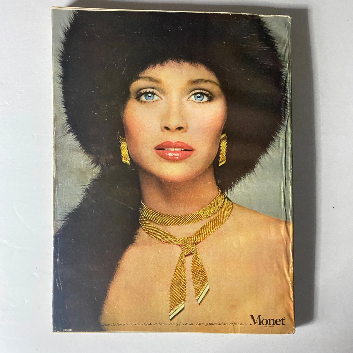 Back cover of Harper's Bazaar Magazine September 1977 featuring a model adorned in Monet jewelry, emphasizing fashion accessories of the time.