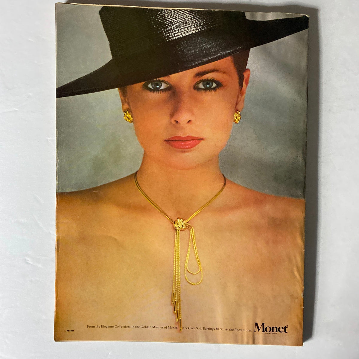 Harper's Bazaar February 1979 featuring a striking ad for Monet jewelry, highlighting a model adorned with a hat and gold necklace, representing the vintage fashion aesthetic.