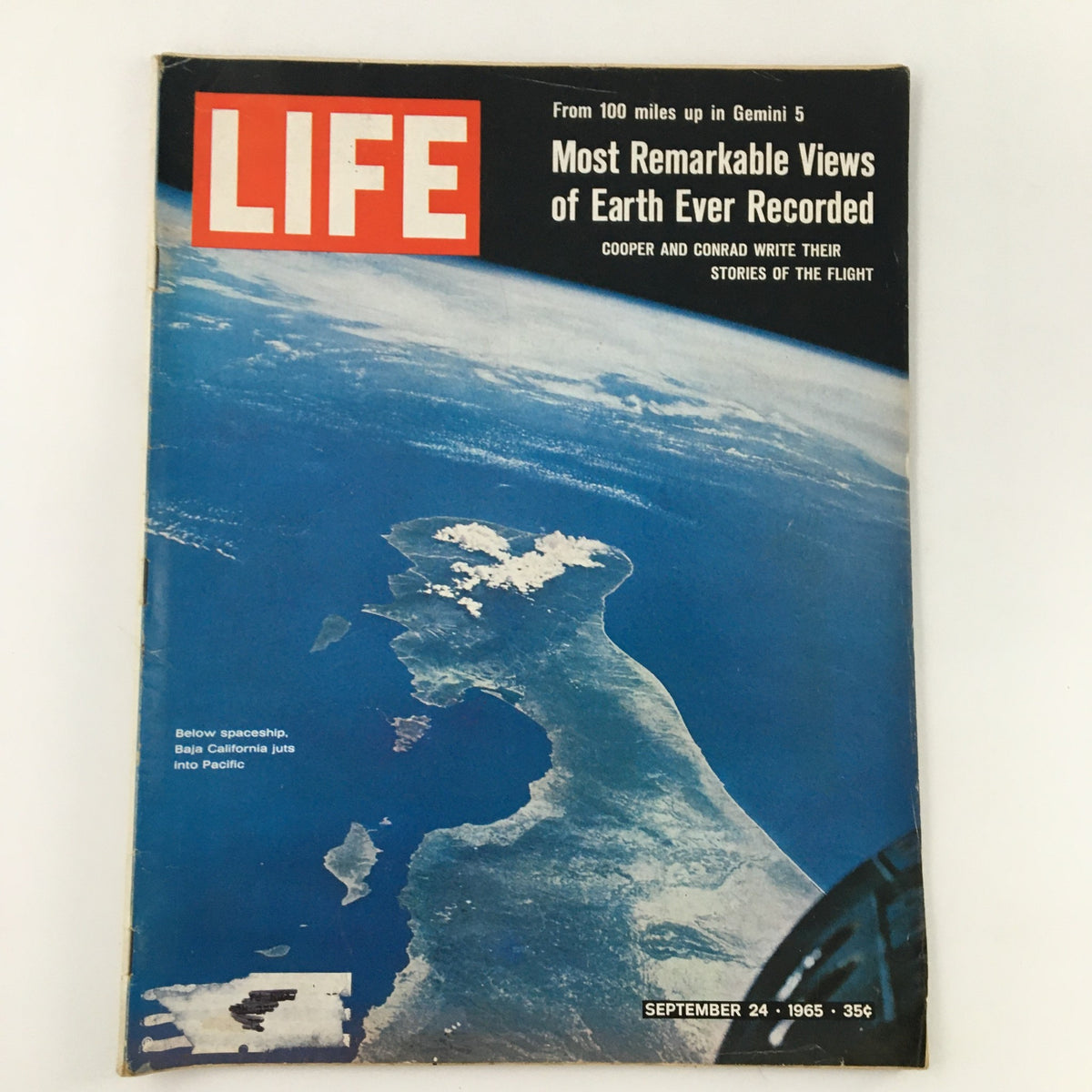 Cover of Life Magazine dated September 24, 1965, featuring a below spaceship view of Baja California, showcasing stunning aerial imagery from the Gemini 5 mission. The magazine highlights remarkable views of Earth, with a title and date prominently displayed.