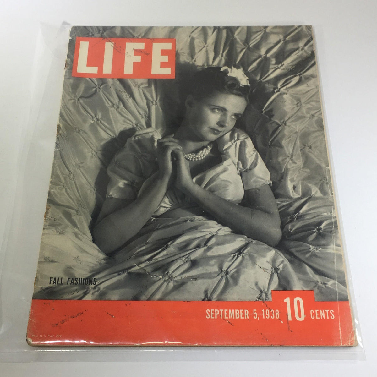Vintage Life Magazine cover from September 5, 1938, featuring fall fashions, showing a woman elegantly posed in a decorative setting with pearls, capturing the fashion trends of the late 1930s.