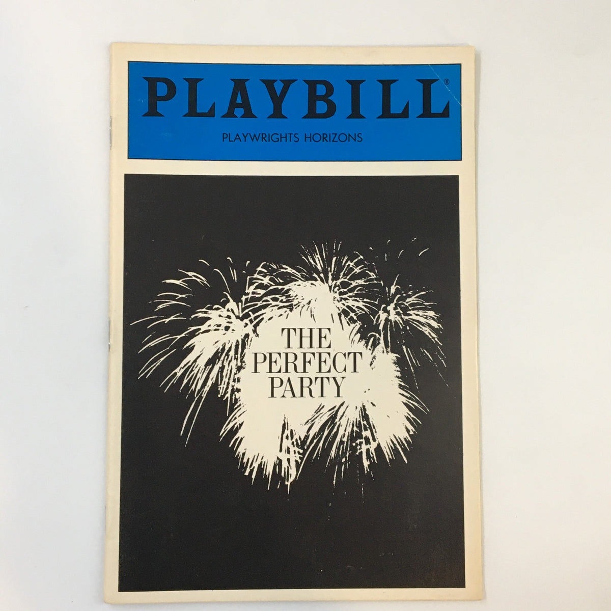 1986 Playbill for The Perfect Party by A.R. Gurney Jr. featuring a design of fireworks on the cover, representing Playwrights Horizons.