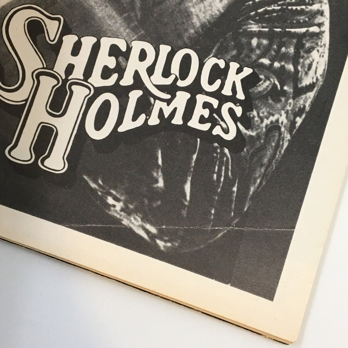 Close-up of the title section from the 1975 Playbill Broadhurst Theatre, highlighting the bold 'Sherlock Holmes' caption with artistic design elements.