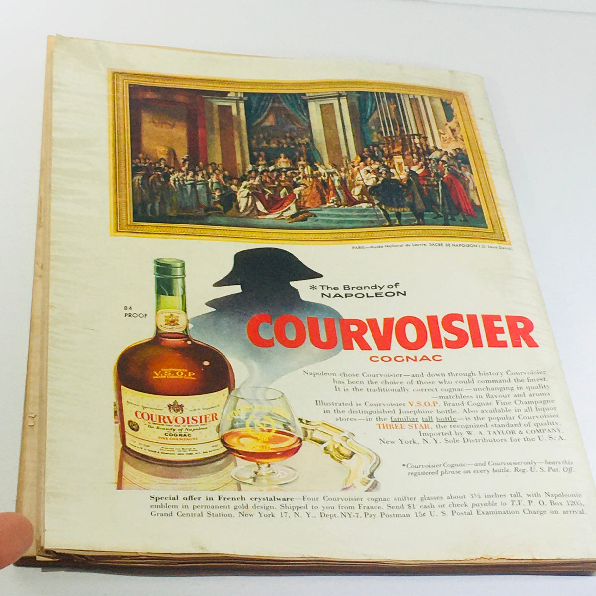 Advertisement from The New Yorker October 22 1955 for Courvoisier Cognac, displaying an elegant bottle and glass with a historical painting backdrop, emphasizing luxury and tradition.