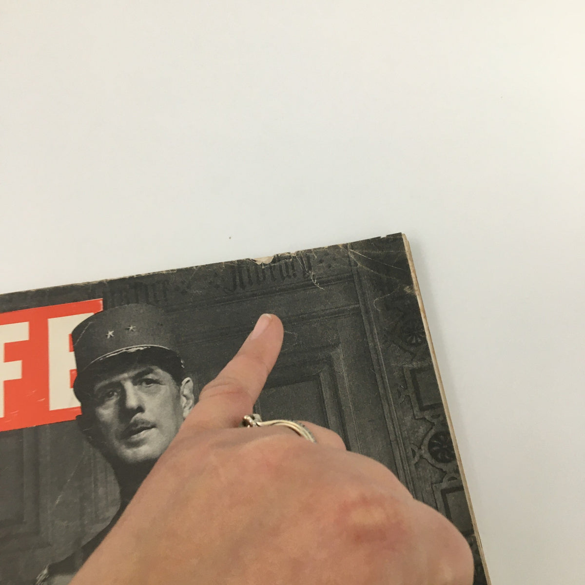 Close-up of the cover of VTG Life Magazine November 13, 1944 with a hand pointing to the top, highlighting its vintage characteristics.
