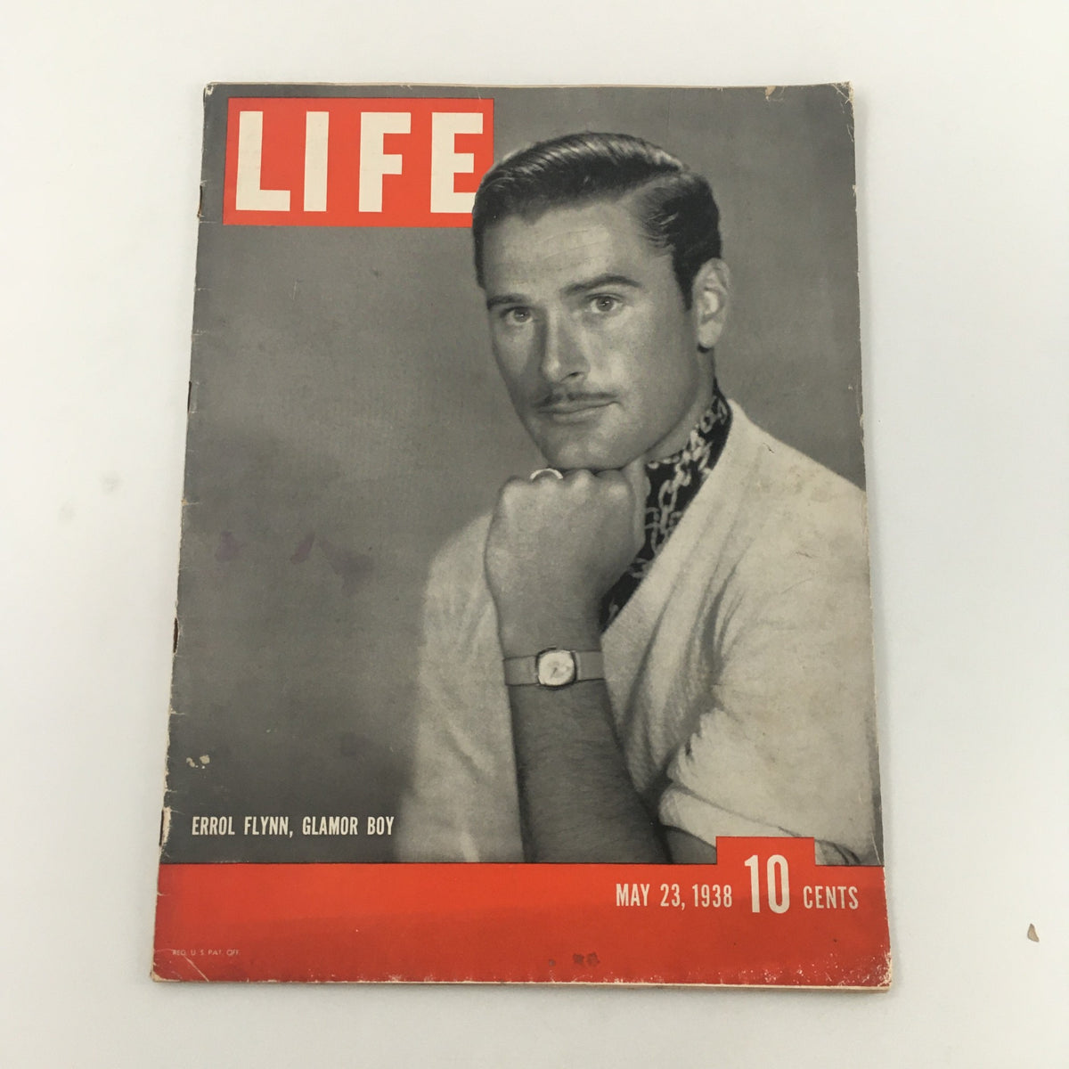 Cover of VTG Life Magazine May 23 1938 featuring Errol Flynn, A Glamor Boy Feature. The magazine shows a portrait of Errol Flynn with a stylish look, emphasizing vintage Hollywood glamour.