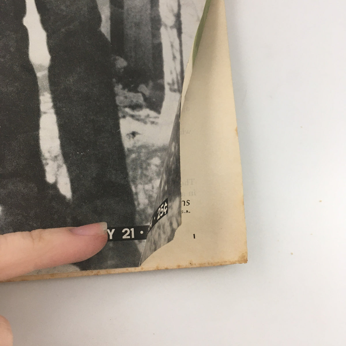 Close-up of the bottom corner of the February 21, 1964 issue of Life Magazine with a visible date and price, featuring Lee Harvey Oswald.