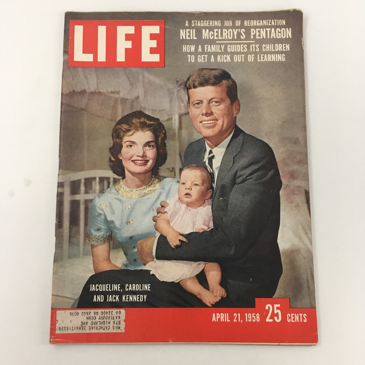 Vintage Life Magazine cover from April 21, 1958, featuring an iconic portrait of Jacqueline Kennedy, her daughter Caroline, and President John F. Kennedy. This historical magazine captures a significant moment in American culture with a charming layout and nostalgic imagery.